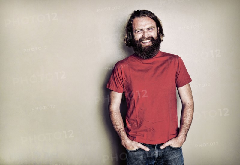 Caucasian man standing with hands in pockets