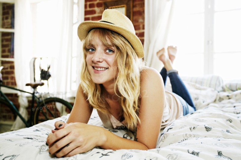 Caucasian woman laying on bed in bedroom