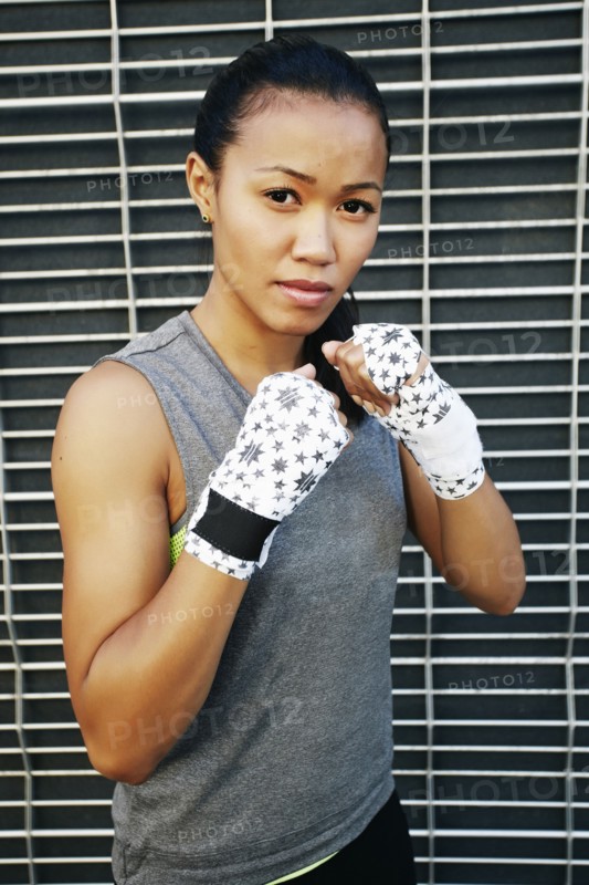 Mixed race athlete with raised fists