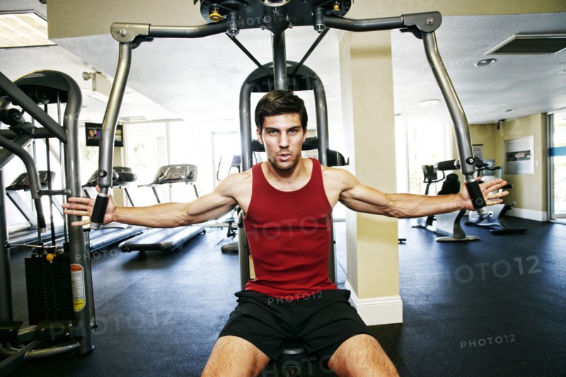 Caucasian man working out in gymnasium