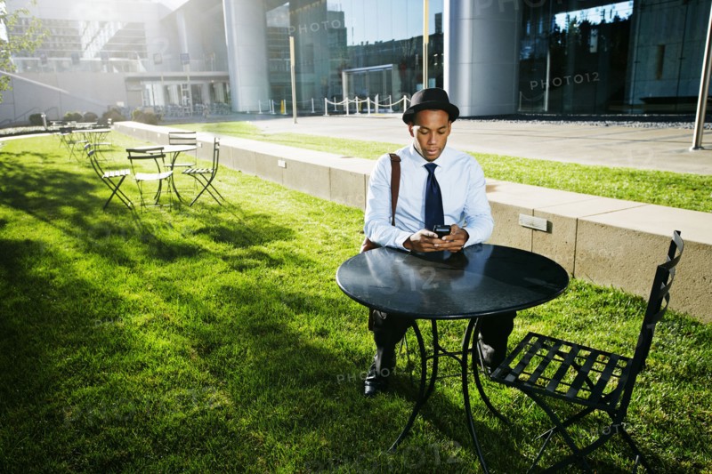 Black businessman using cell phone outdoors