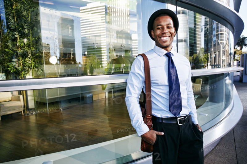 Black businessman smiling outside office building