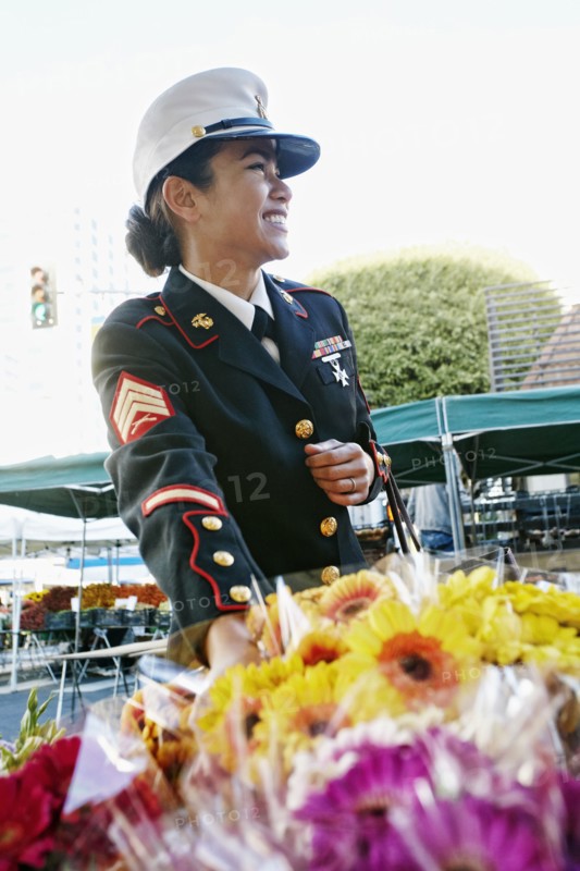 Asian soldier shopping in flower market