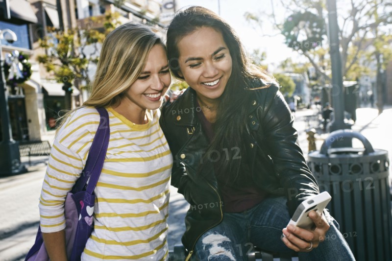 Women using cell phone outdoors