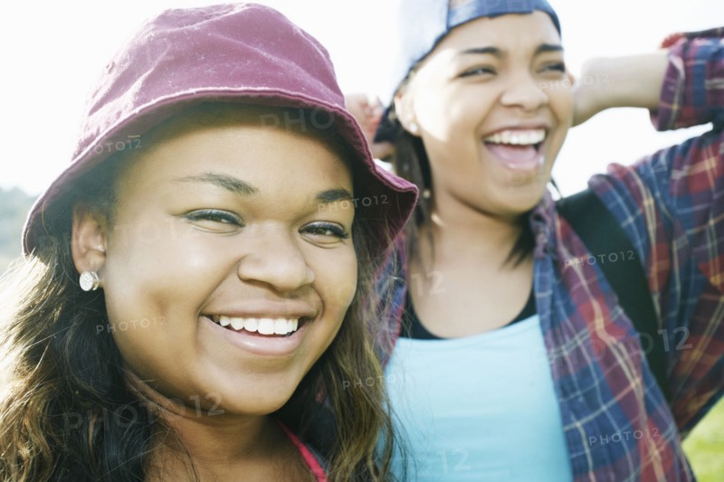 Mixed Race sisters laughing outdoors