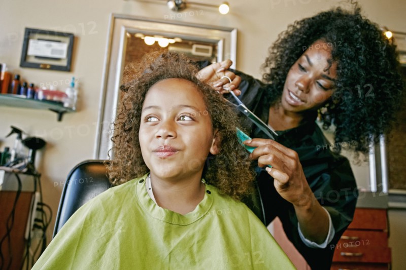 Smiling hairdresser and customer in hair salon
