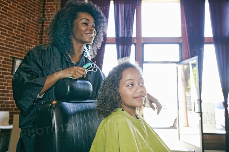 Smiling hairdresser and customer in hair salon