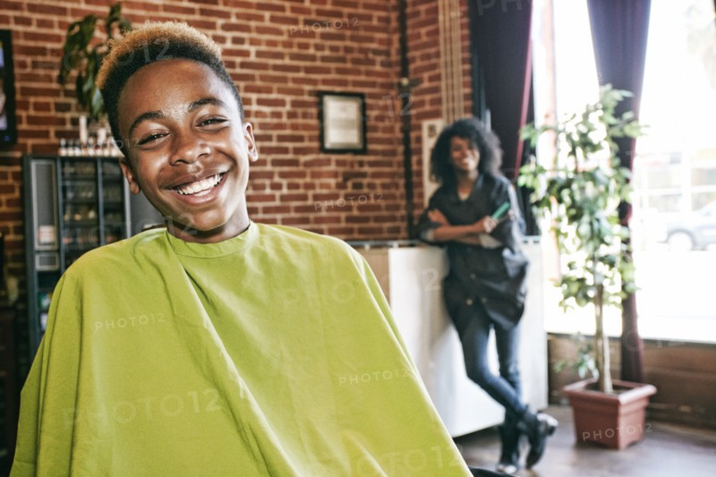 Smiling hairdresser and customer in hair salon