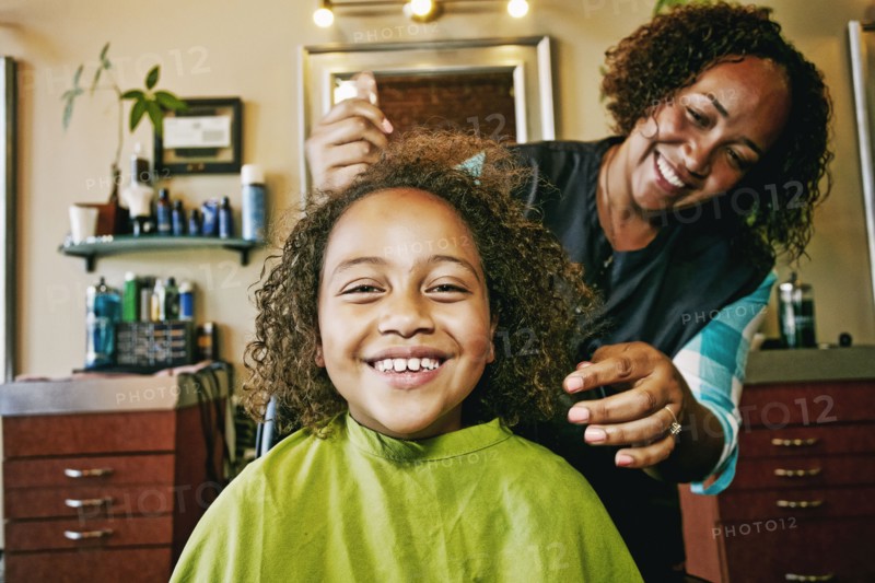 Smiling hairdresser and customer in hair salon