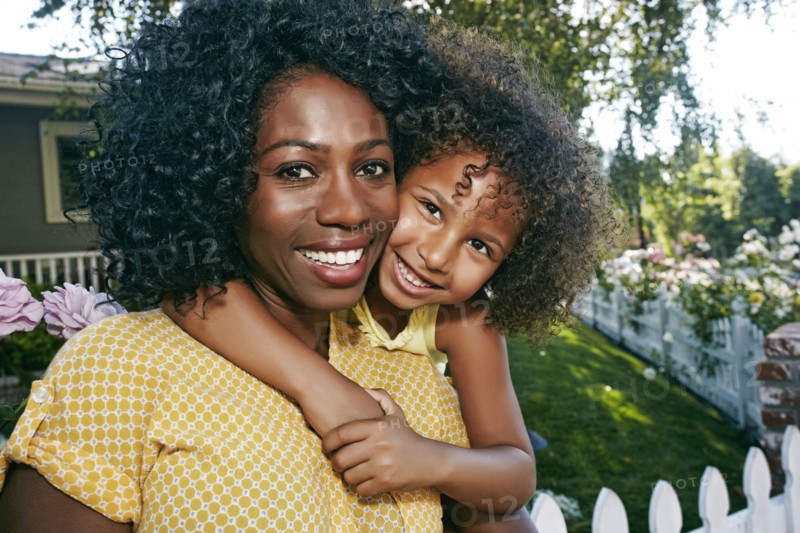 Daughter hugging mother outdoors