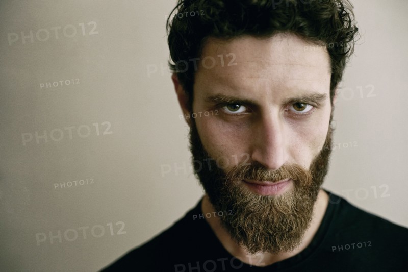 Serious Caucasian man with beard looking at camera