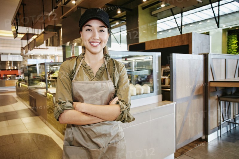 Portrait of smiling Mixed Race worker in food court