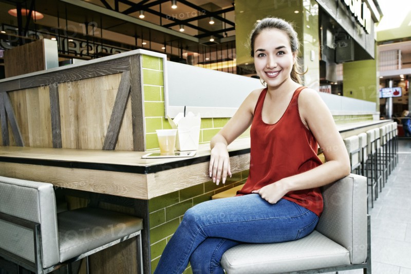 Smiling Mixed Race woman posing in food court