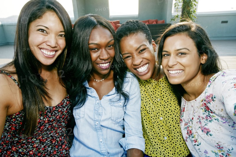 Smiling women posing on rooftop