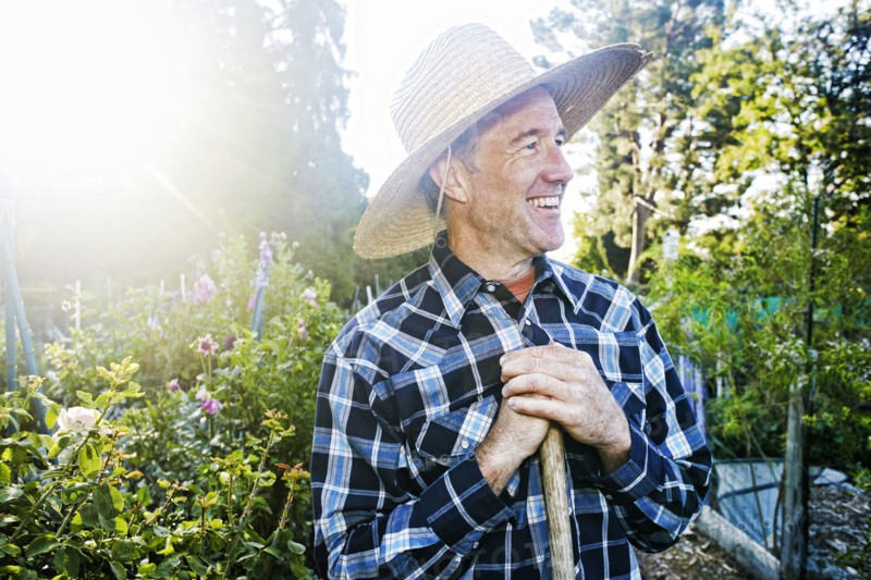 Smiling Caucasian man standing in garden