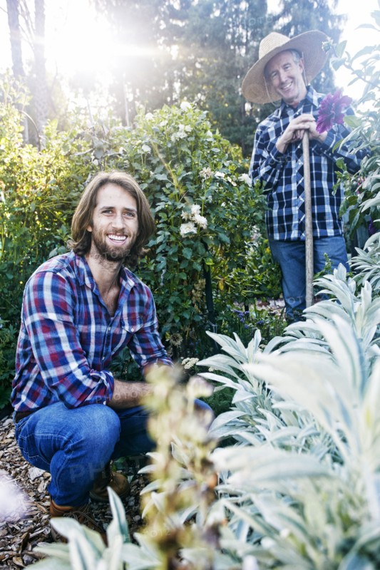 Smiling Caucasian men posing in garden