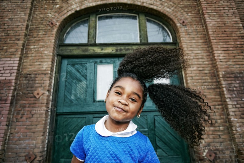Smiling Black girl tossing hair