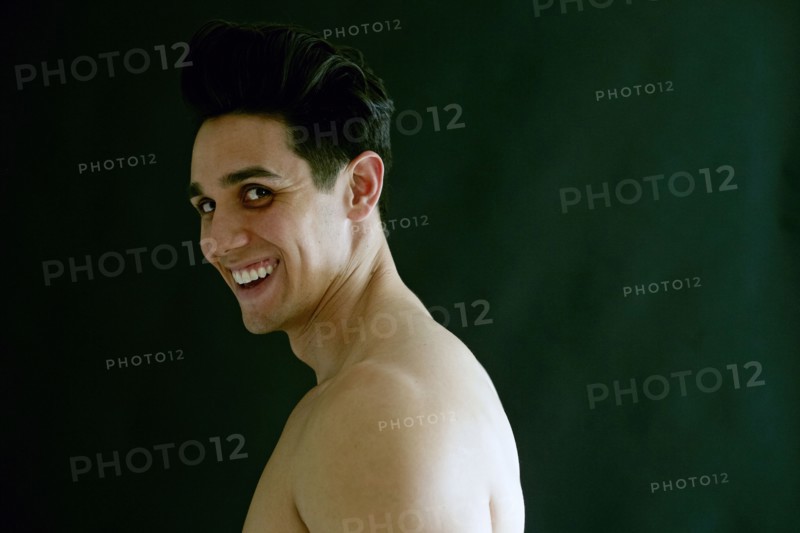 Portrait of naked Caucasian man laughing