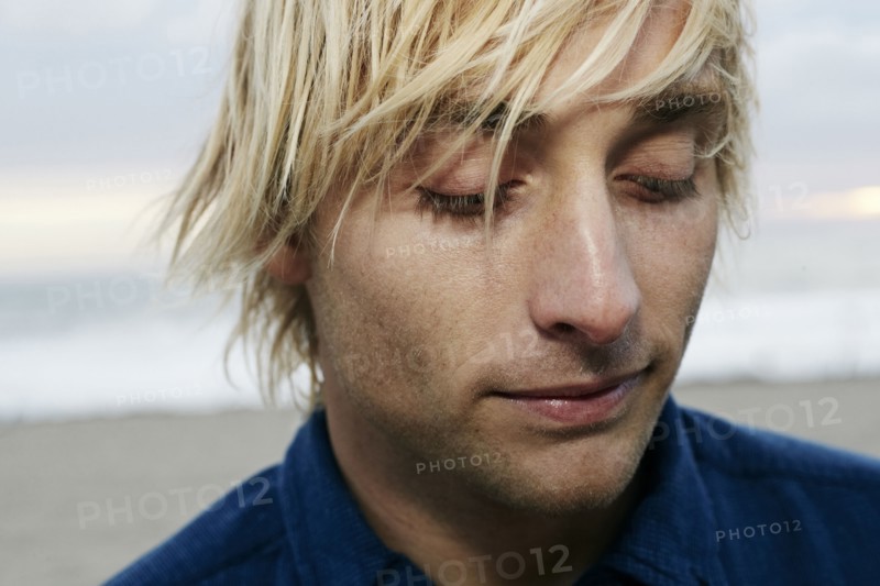 Portrait of pensive Caucasian man at beach