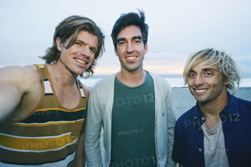 Portrait of smiling Caucasian men at beach