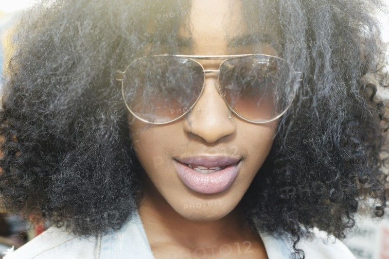 Close up of mixed race woman wearing sunglasses