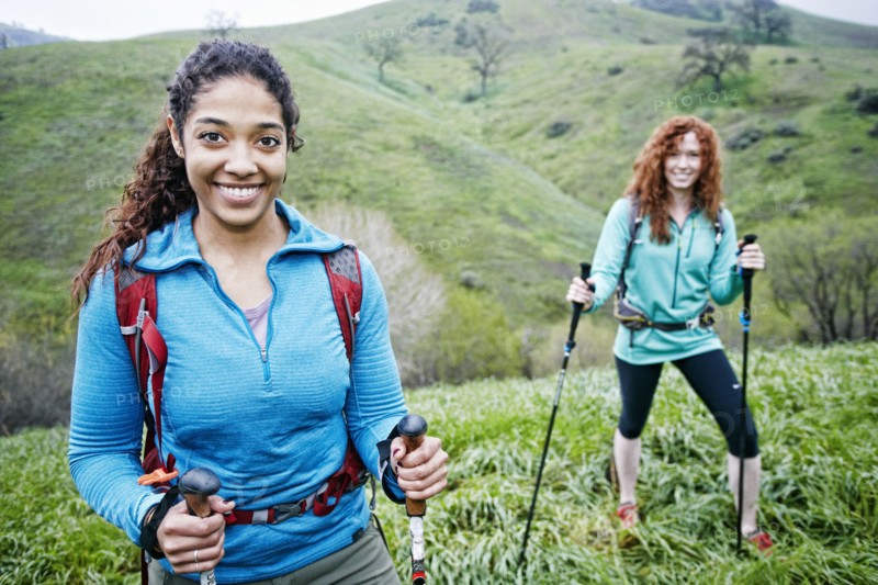Portrait of smiling women hiking with walking sticks