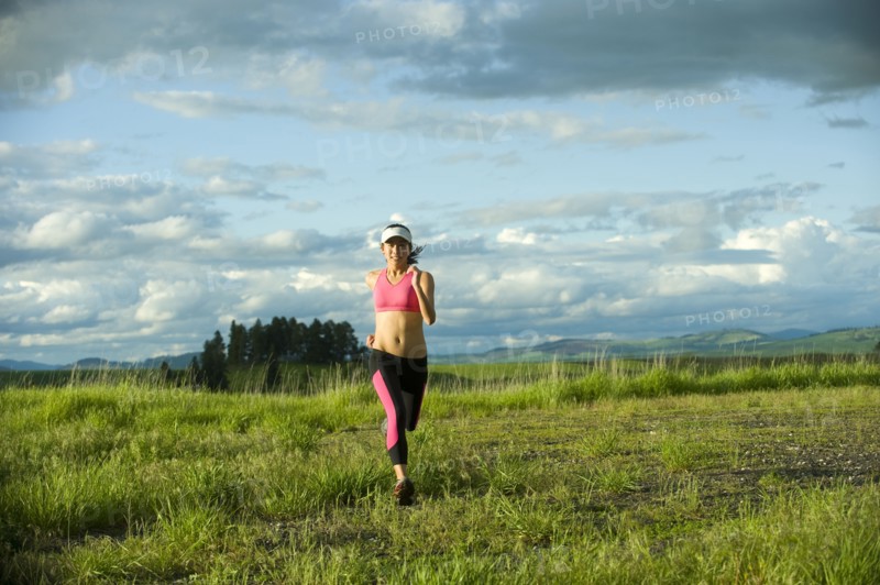 Japanese woman running in field