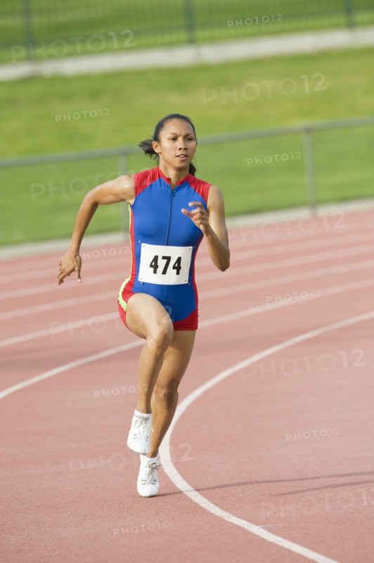 Mixed race runner running on racetrack