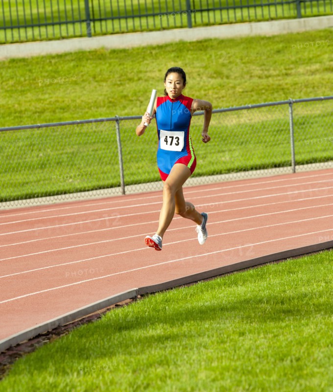Japanese runner running on racetrack