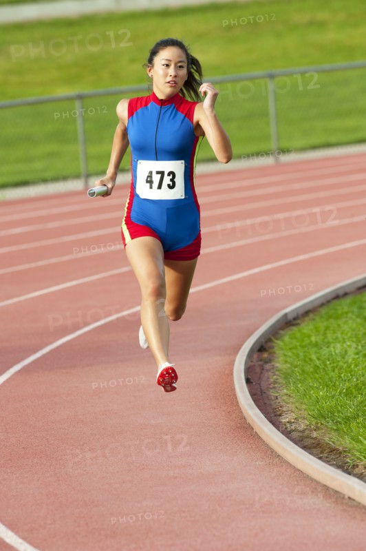 Japanese runner running on racetrack