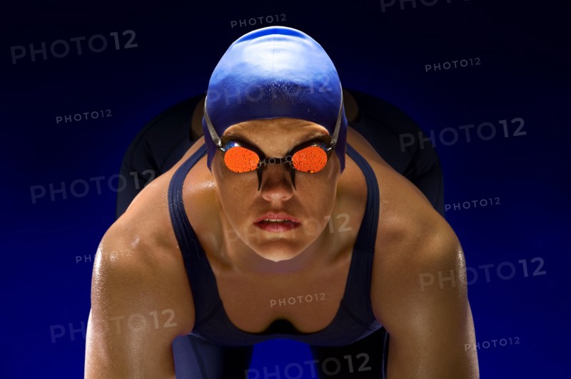 Serious swimmer in swim cap and goggles