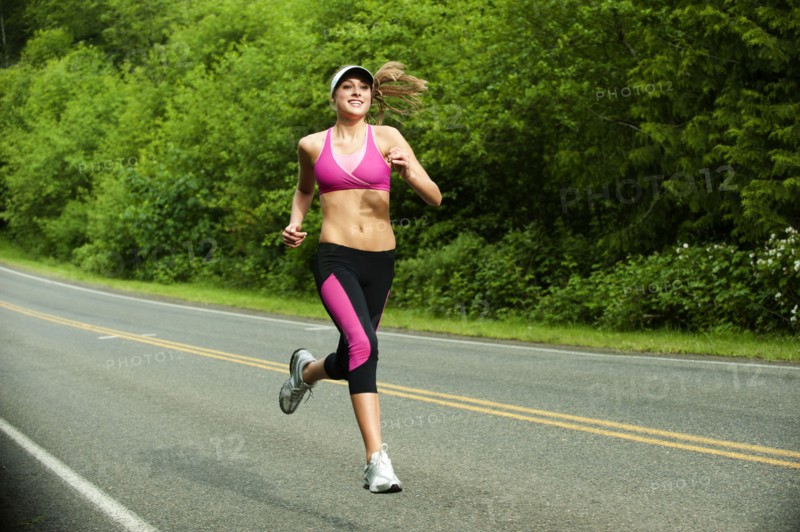 Caucasian woman running on remote road