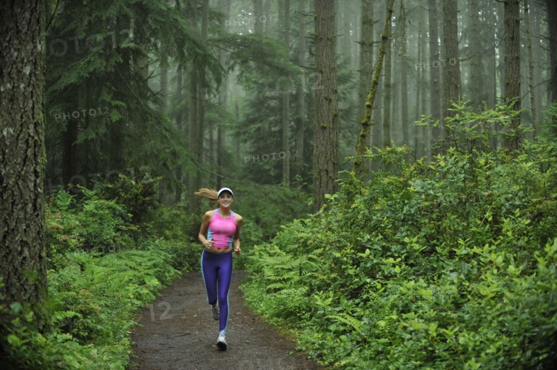 Caucasian woman running on remote path