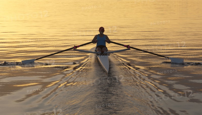 Person rowing sculling boat on river