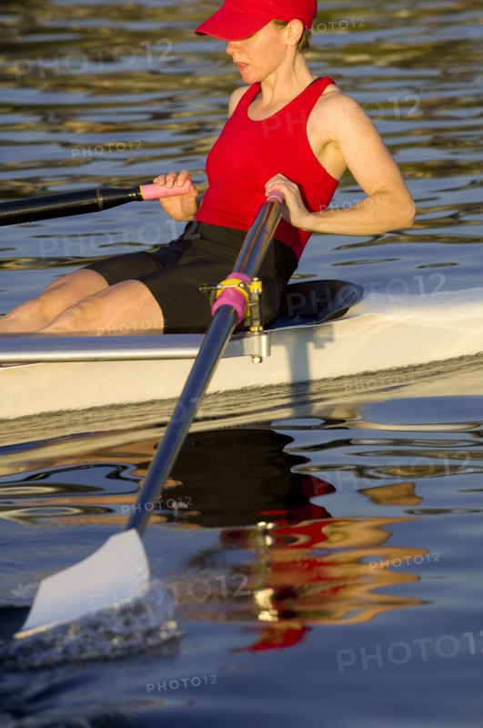 Person rowing sculling boat on river
