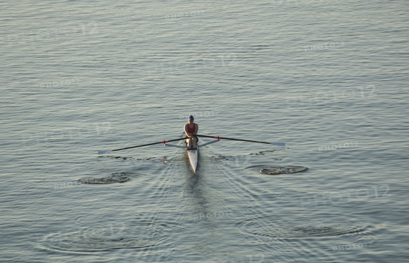 Person rowing sculling boat on river