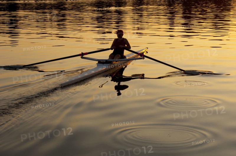 Person rowing sculling boat on river