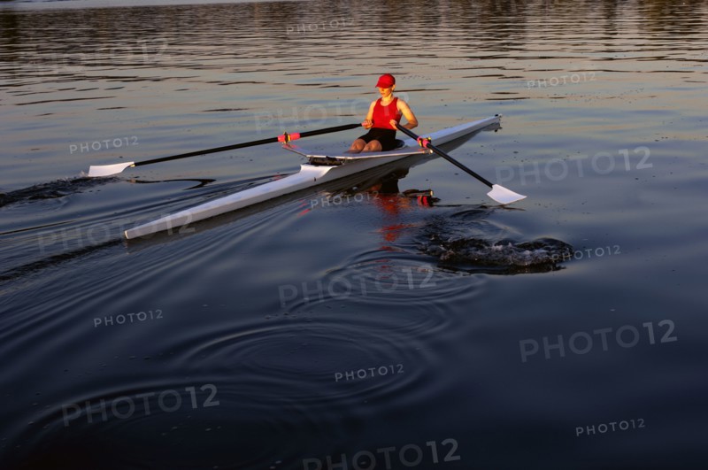 Person rowing sculling boat on river