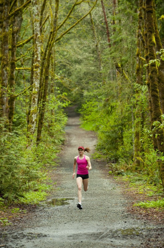 Mixed race woman running on remote path