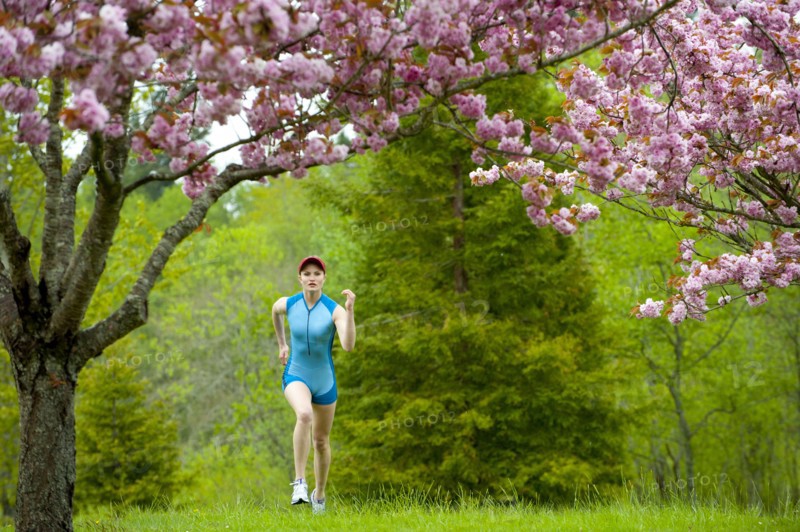 Mixed race runner jogging across grass