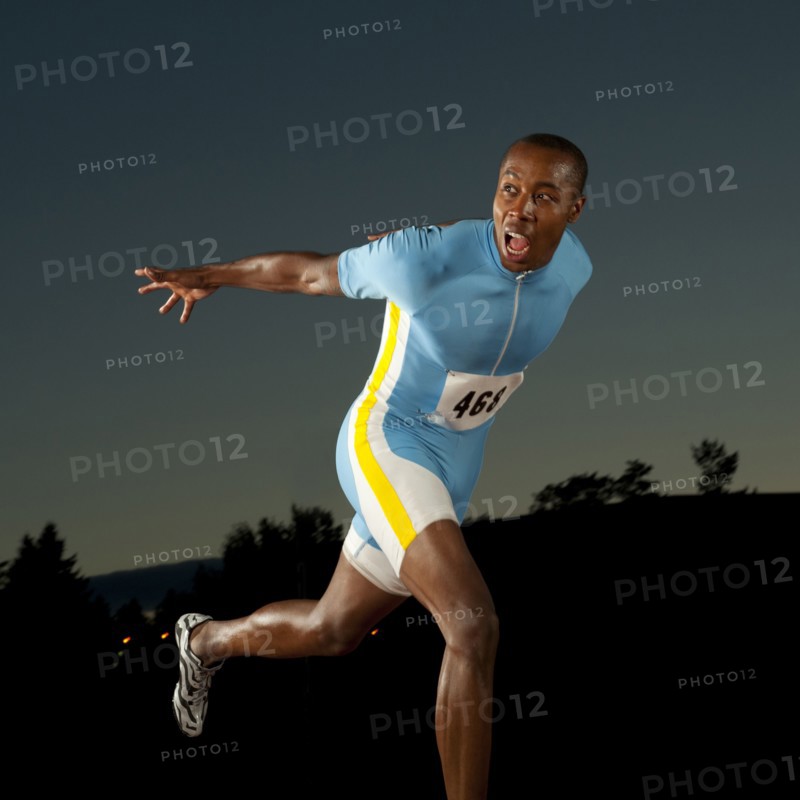Black runner crossing finish line in race