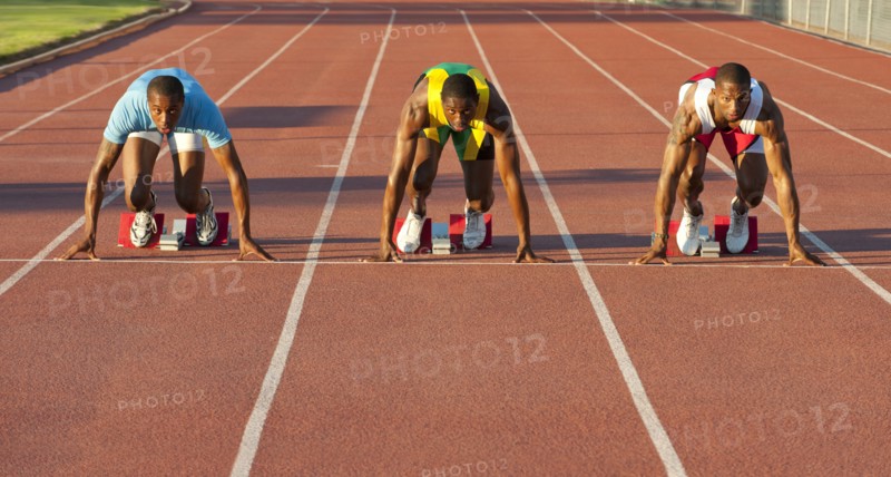Black runners at starting block in race