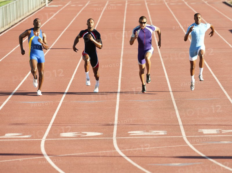 Runners running on track in race