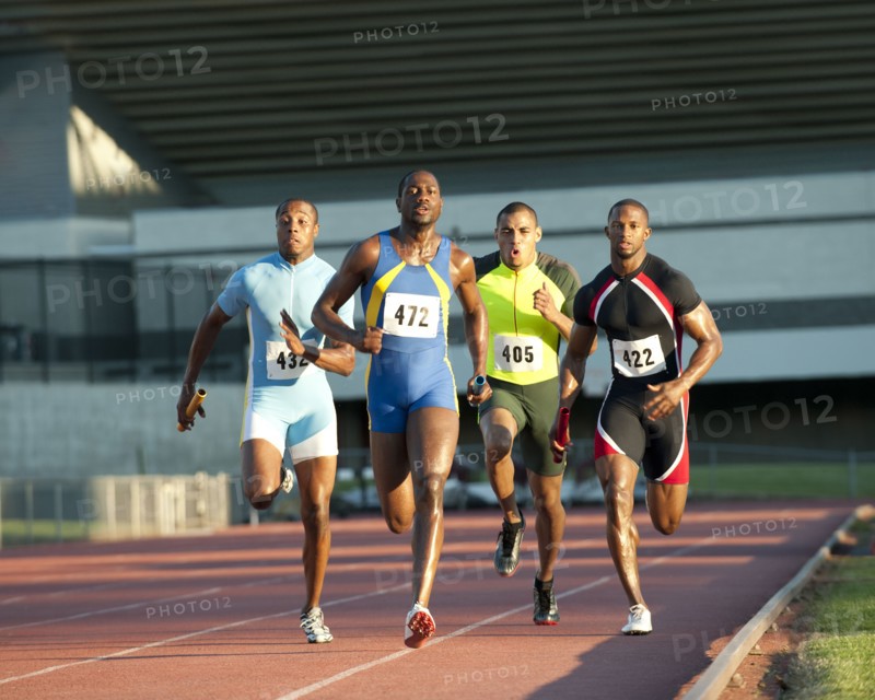 Relay racers running on track in race