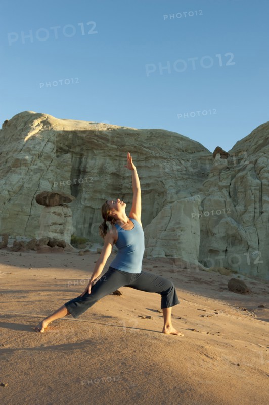 Caucasian woman practicing yoga in desert