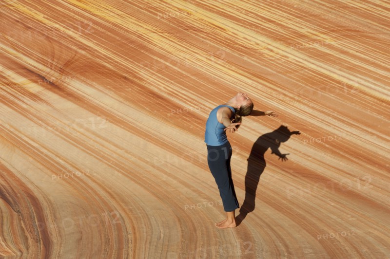 Caucasian woman practicing yoga outdoors
