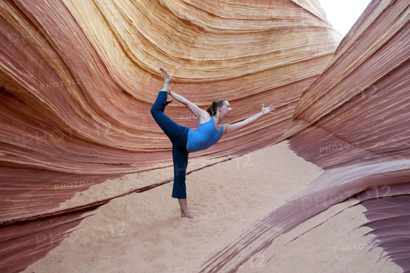 Caucasian woman practicing yoga outdoors