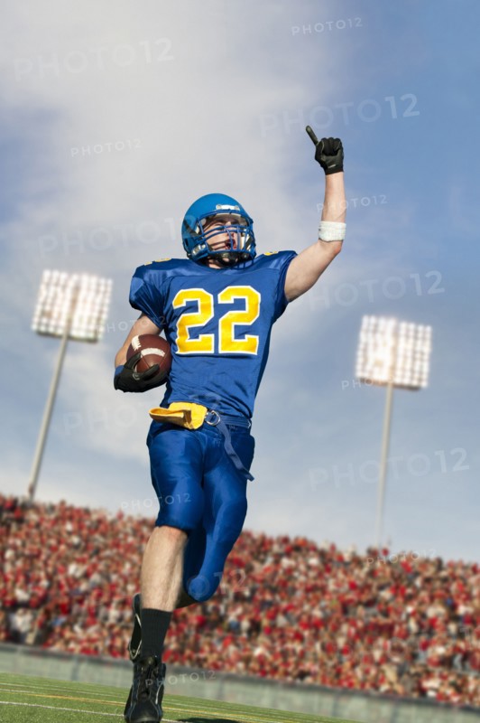Caucasian football player running with ball