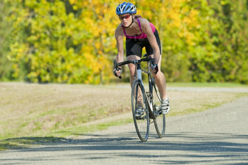 Caucasian woman riding bicycle in park