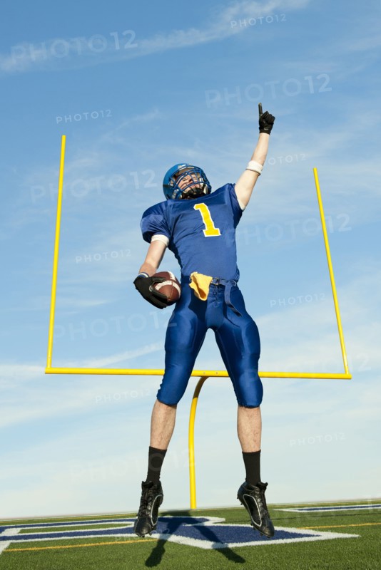 Caucasian football player cheering for victory